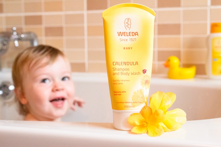 A baby shampoo bottle with a baby in the background